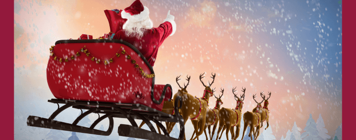 Santa on his sleigh being pulled by reindeer